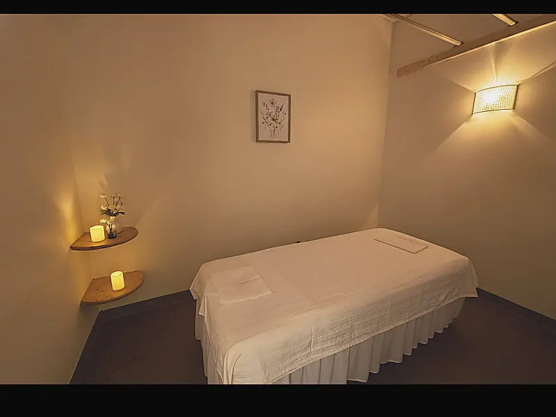 A private treatment room at Day Massage in Chaska, lit low and set up with a draped table